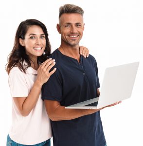Cheery Couple Using Laptop Computer